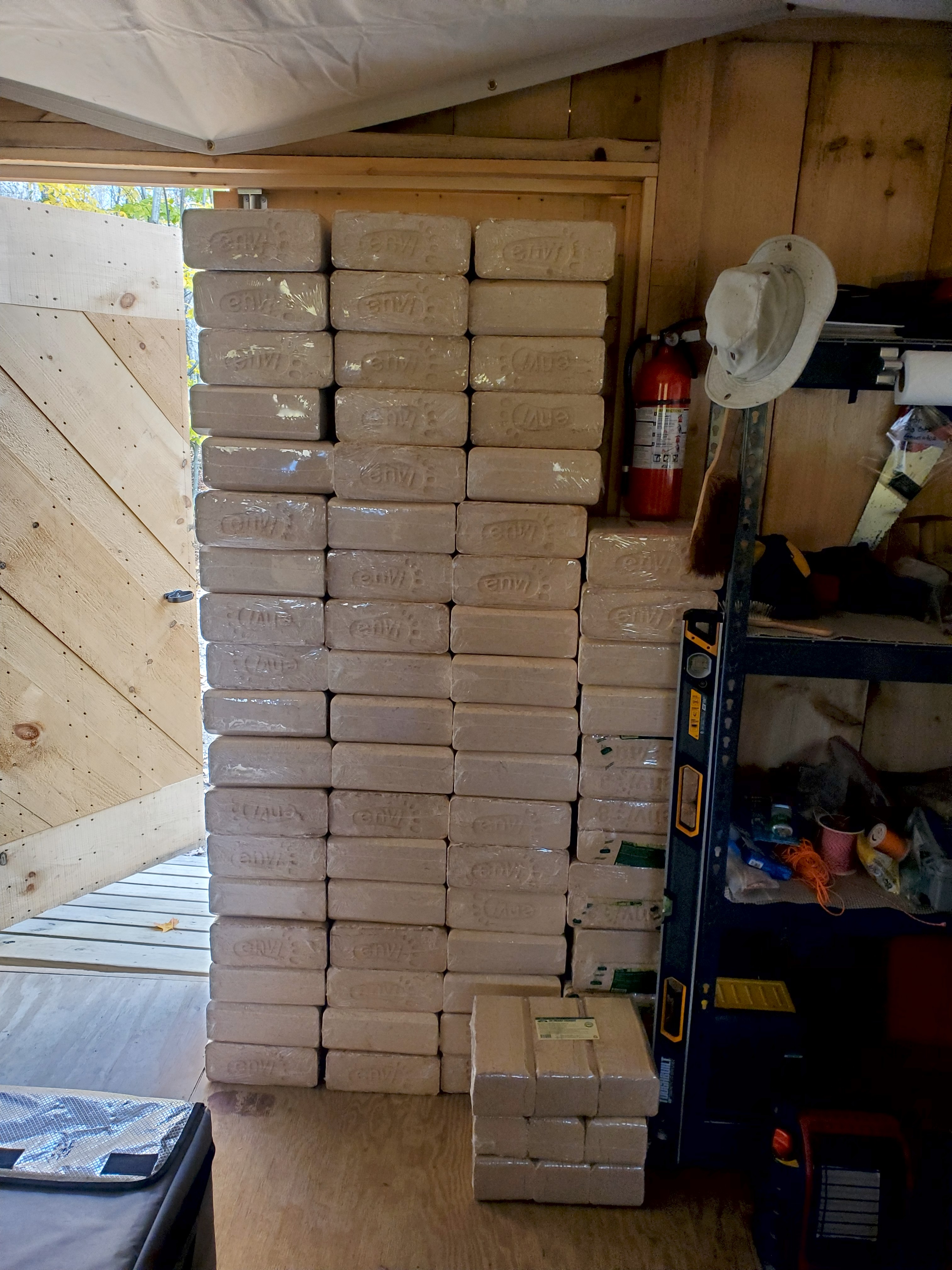 Stacked compressed sawdust bio bricks in the barn